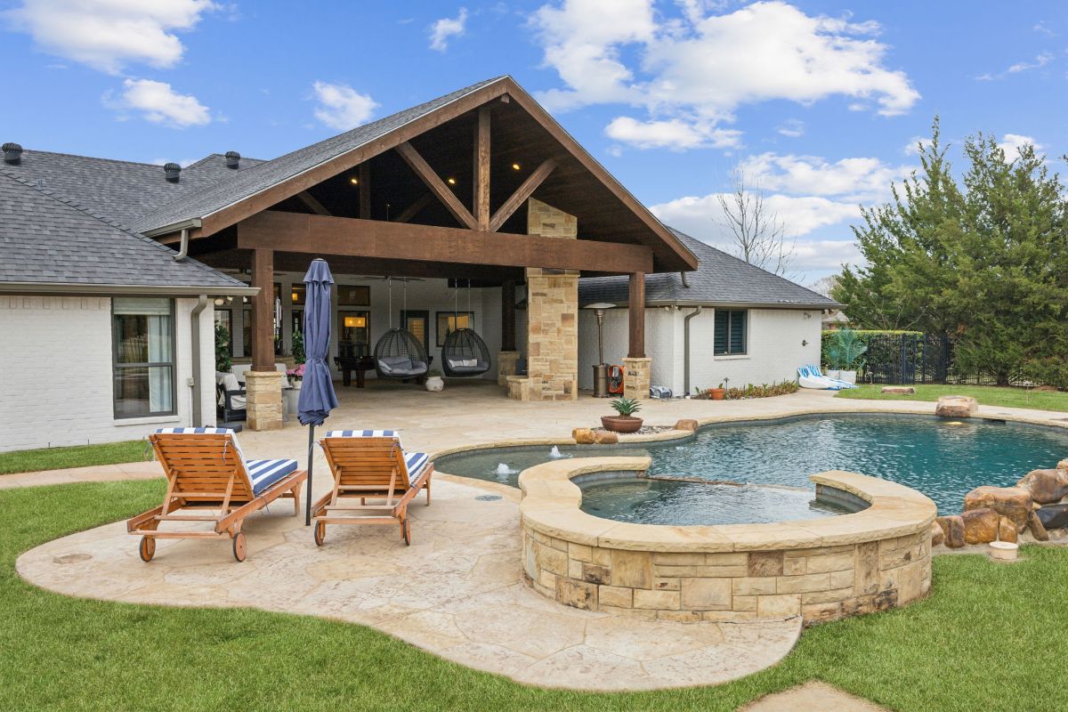 Large gabled roof extends over the outdoor seating area.