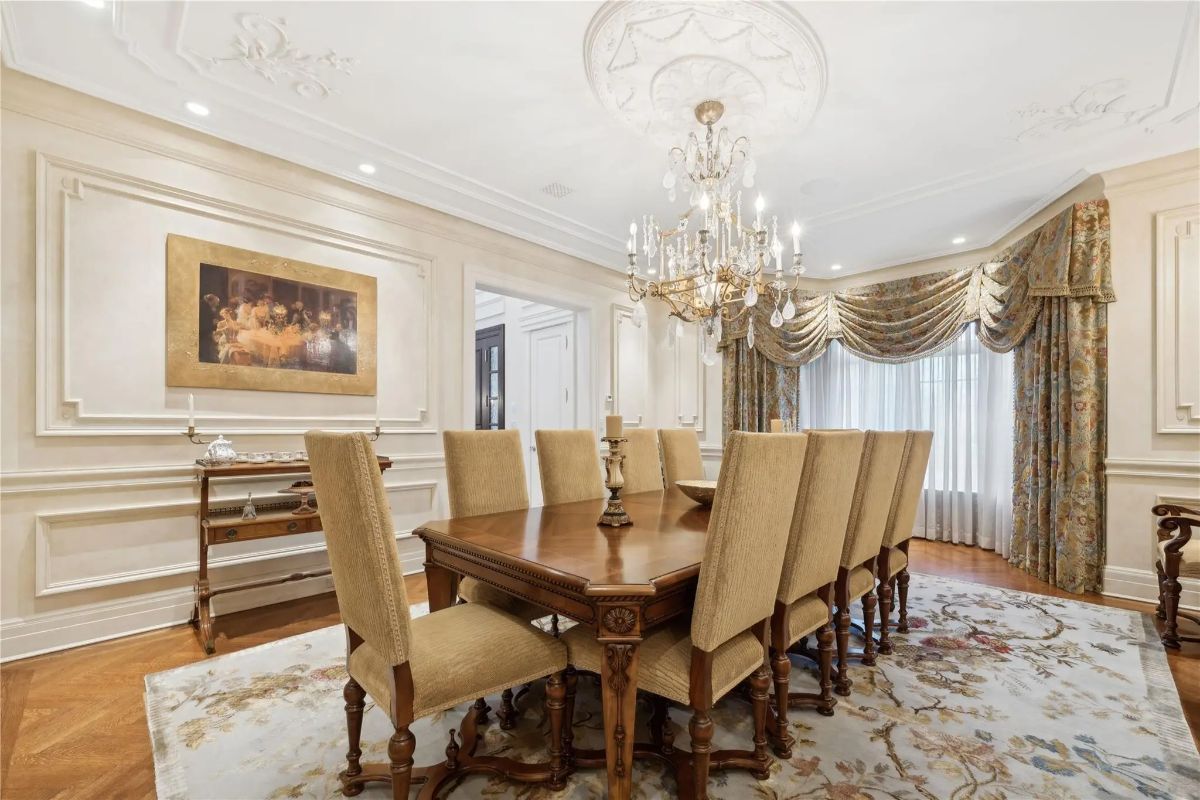 Rectangular wood table is surrounded by ten high-back upholstered chairs.