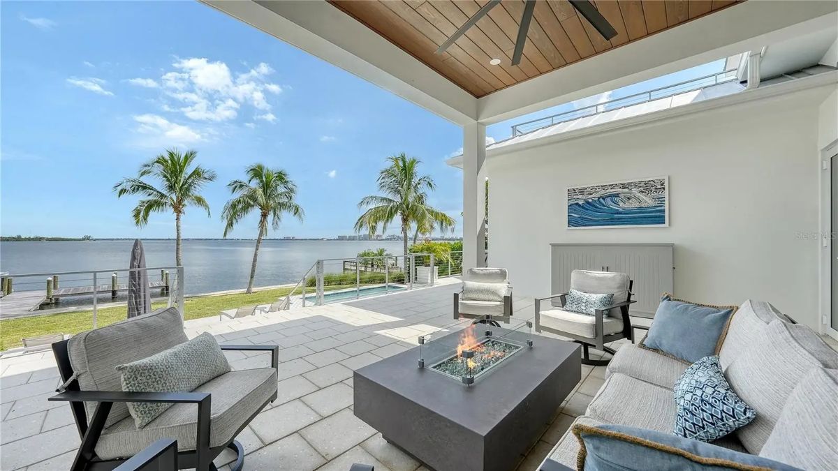 Outdoor lounge with built-in ceiling fan and recessed lighting.