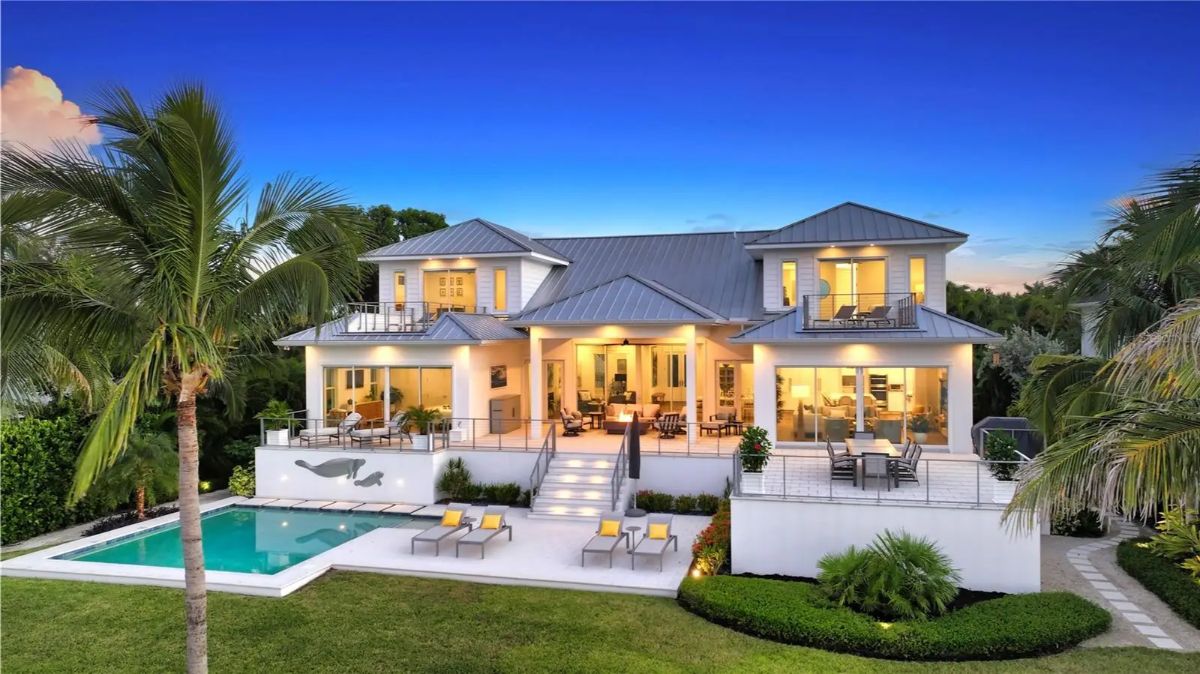 Two-story residence with a symmetrical design and multiple balconies.