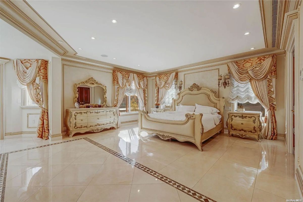 Matching bed, dressers, and nightstands feature ornate detailing and curved lines.