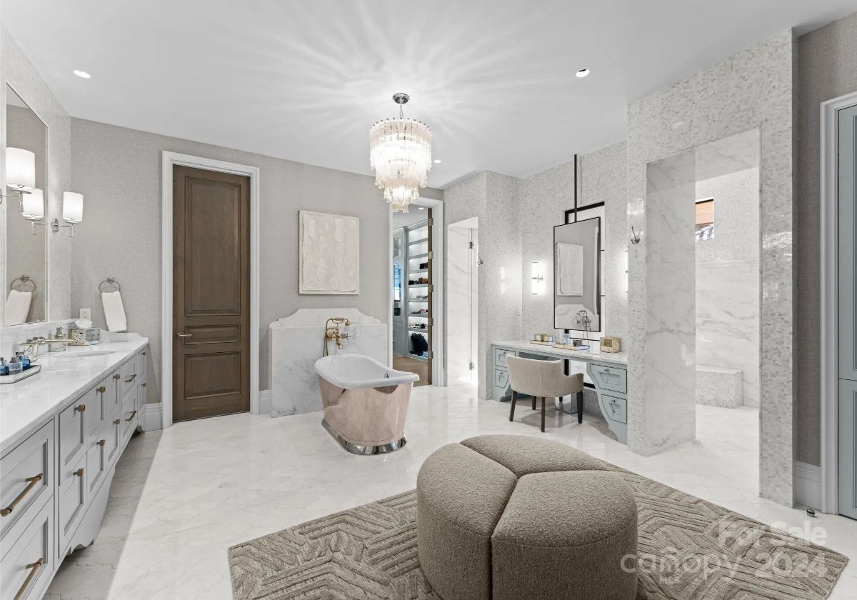 Sparkling chandeliers and marble accents transform this bathroom into a lavish personal retreat. 