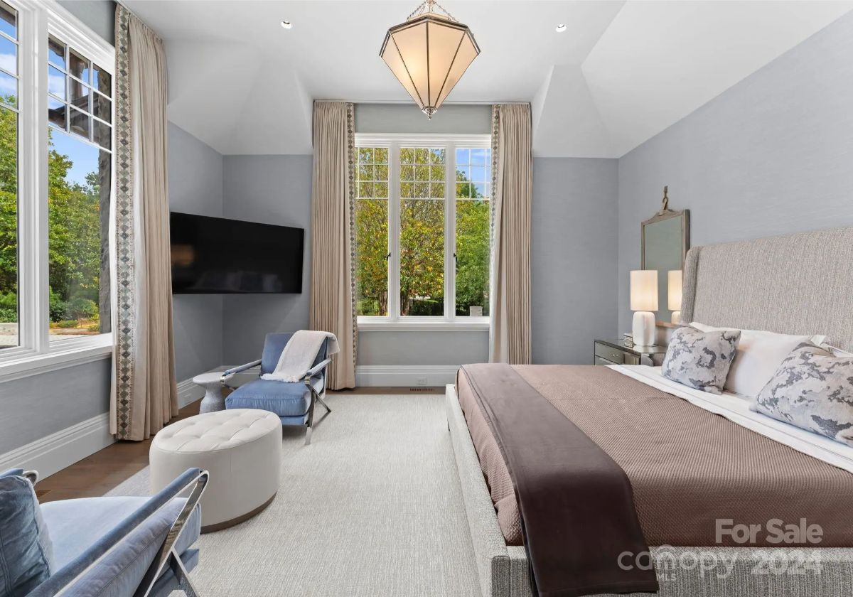 Soft blue tones and rich fabrics create a peaceful retreat in a bedroom designed for serenity. 