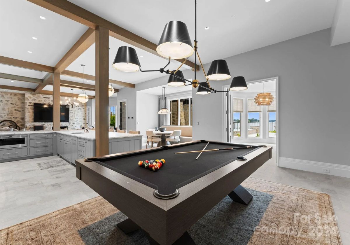 A sophisticated game room with a pool table and bar invites both competition and conversation. 