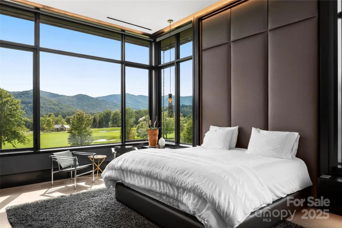 Waking up to panoramic mountain views feels like a dream in this soft, sophisticated bedroom. 