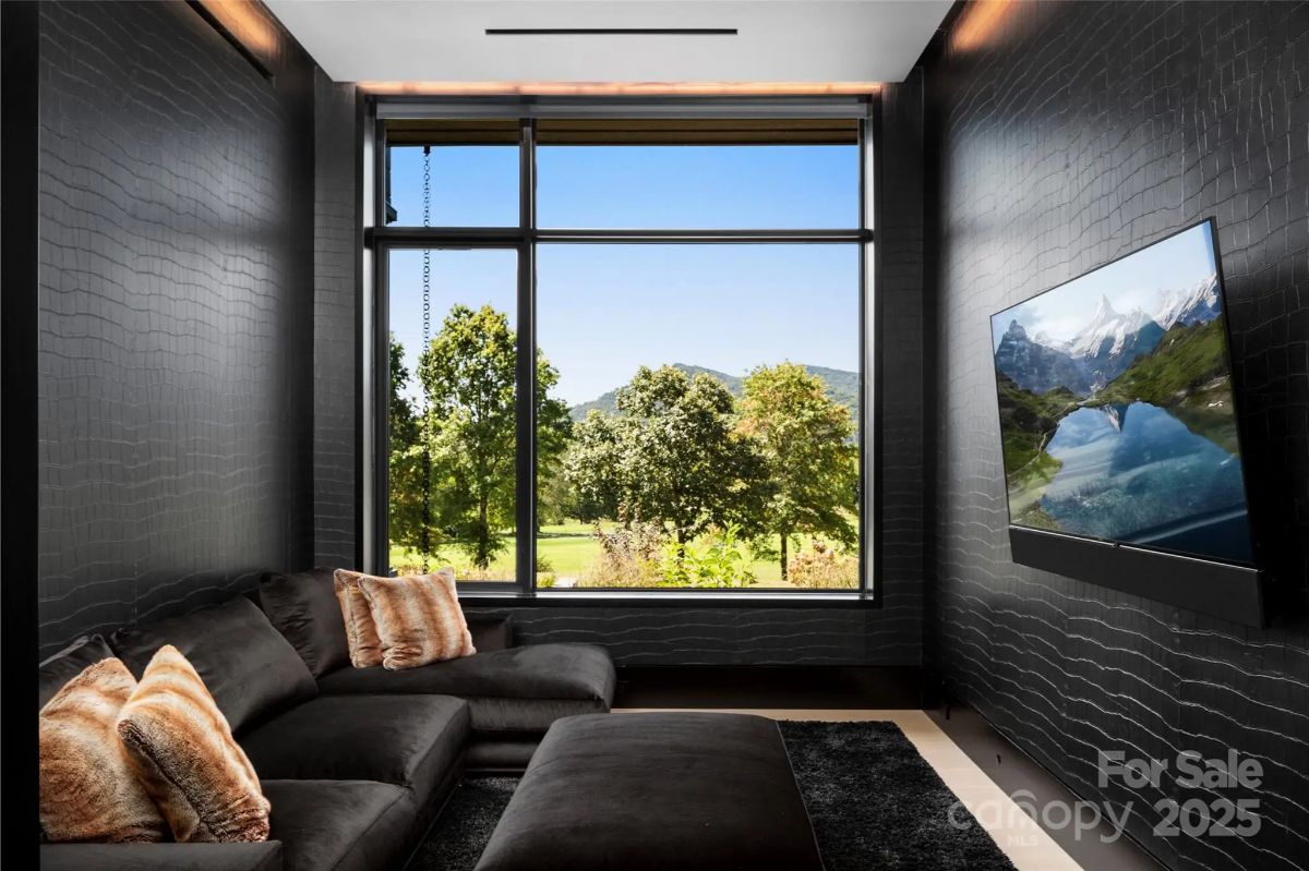 A moody media room wrapped in dark tones transforms movie nights into an immersive experience. 