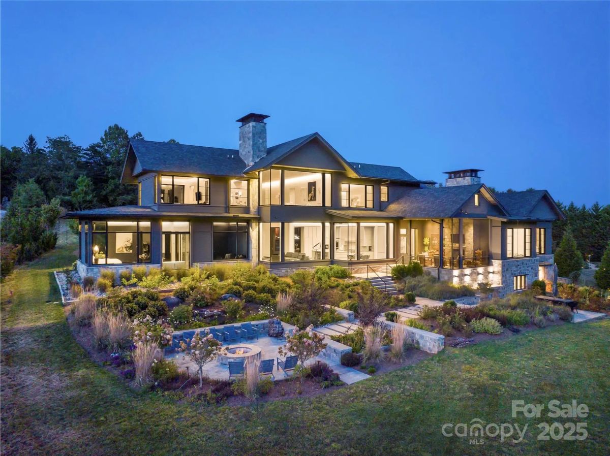 As twilight settles, the glow of the house blends seamlessly with the deep blues of the evening sky. 