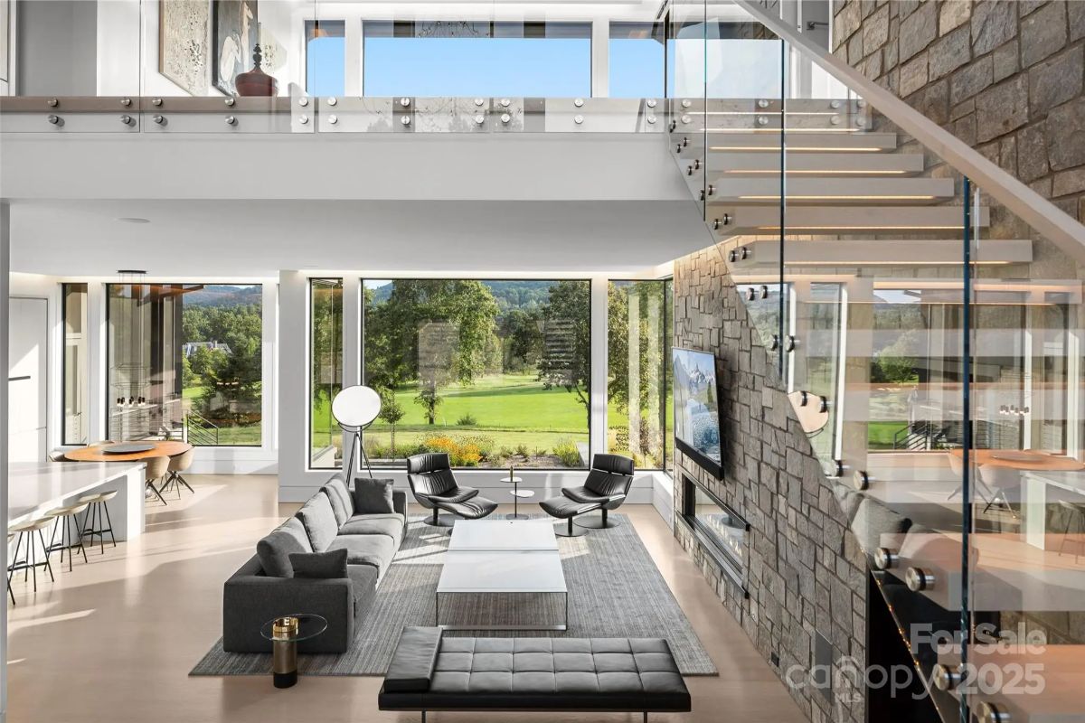 A double-height living space flows seamlessly into the landscape, offering a front-row seat to nature. 