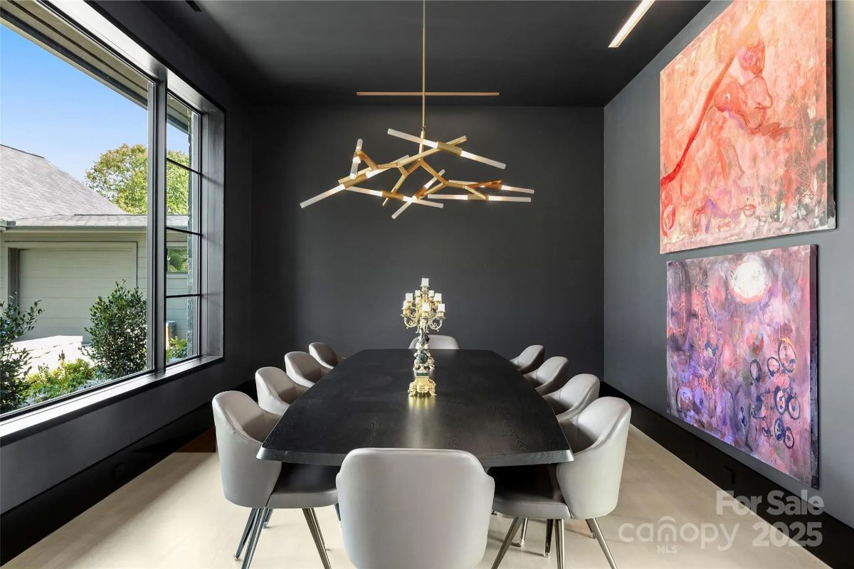 A moody dining room wrapped in deep hues and statement lighting makes every meal an experience. 