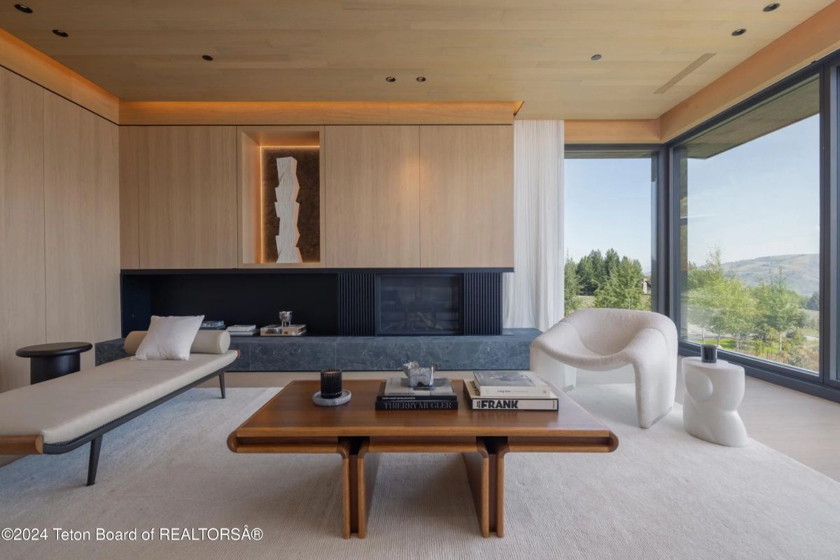 Another angle of the stylish living area, highlighting custom furnishings, warm tones, and a tranquil outdoor view. 