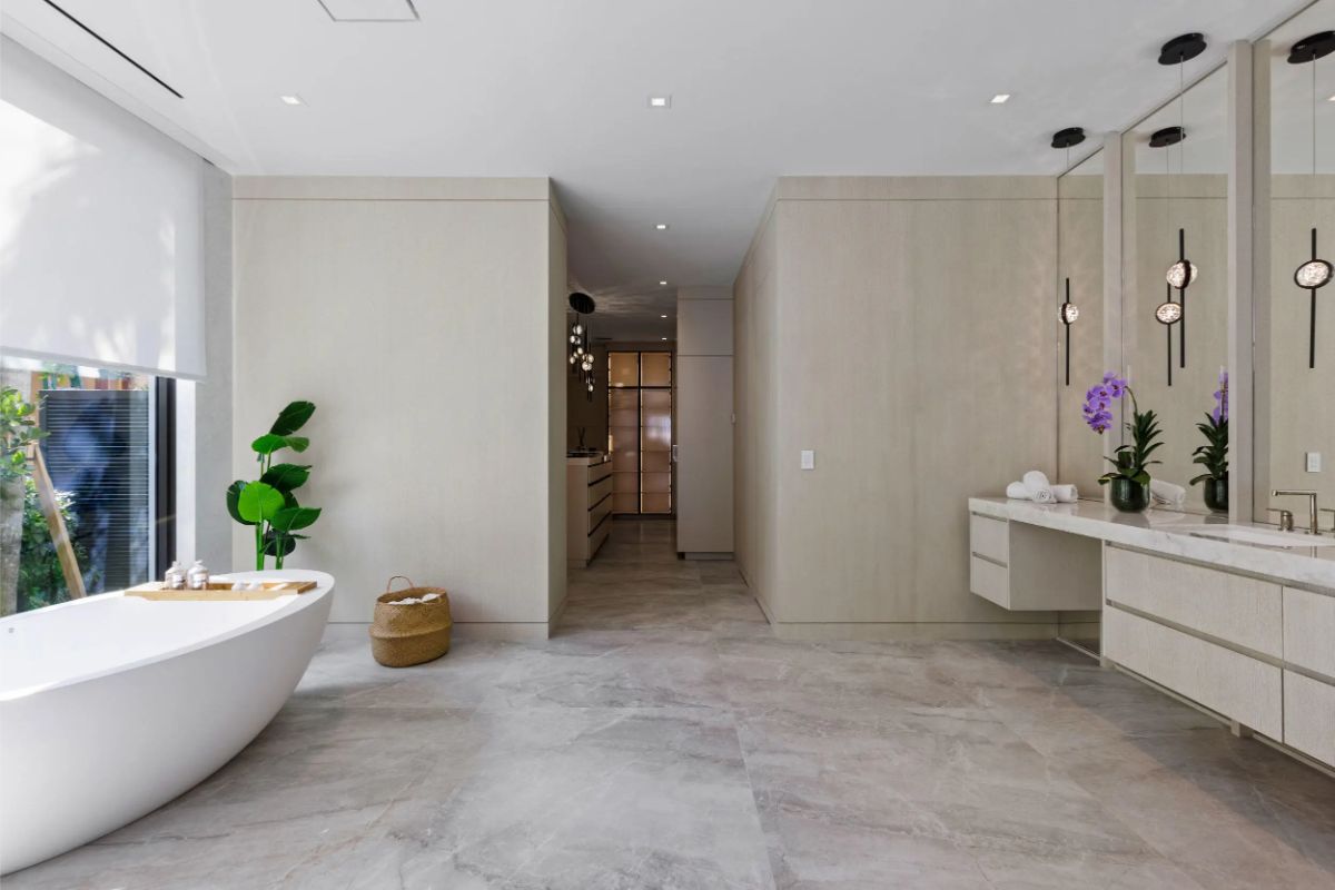 Spacious bathroom layout with dual vanities and warm natural light. 