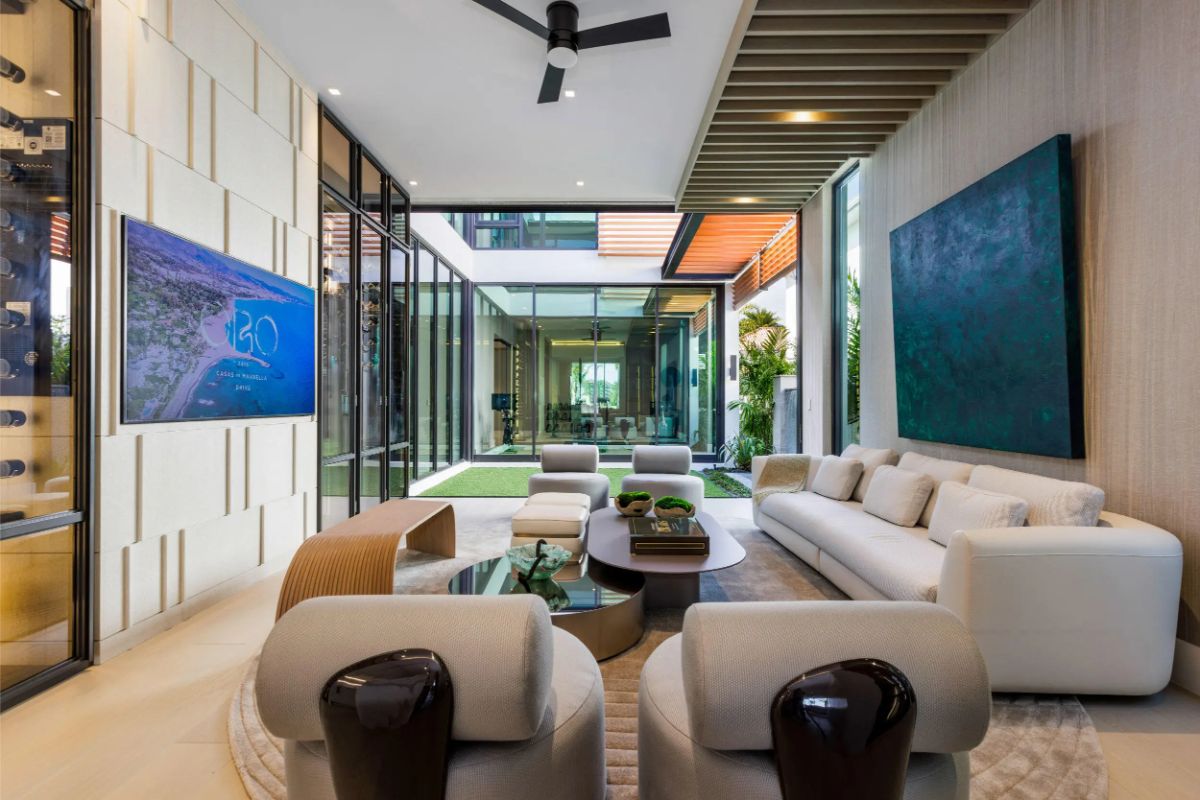 Chic indoor lounge framed by glass walls and stylish architectural details. 