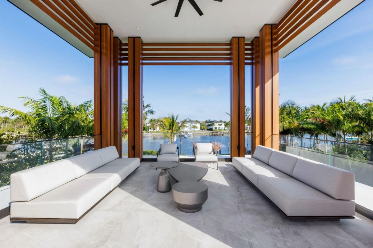 Stunning covered terrace with open water views and symmetrical lounging areas. 