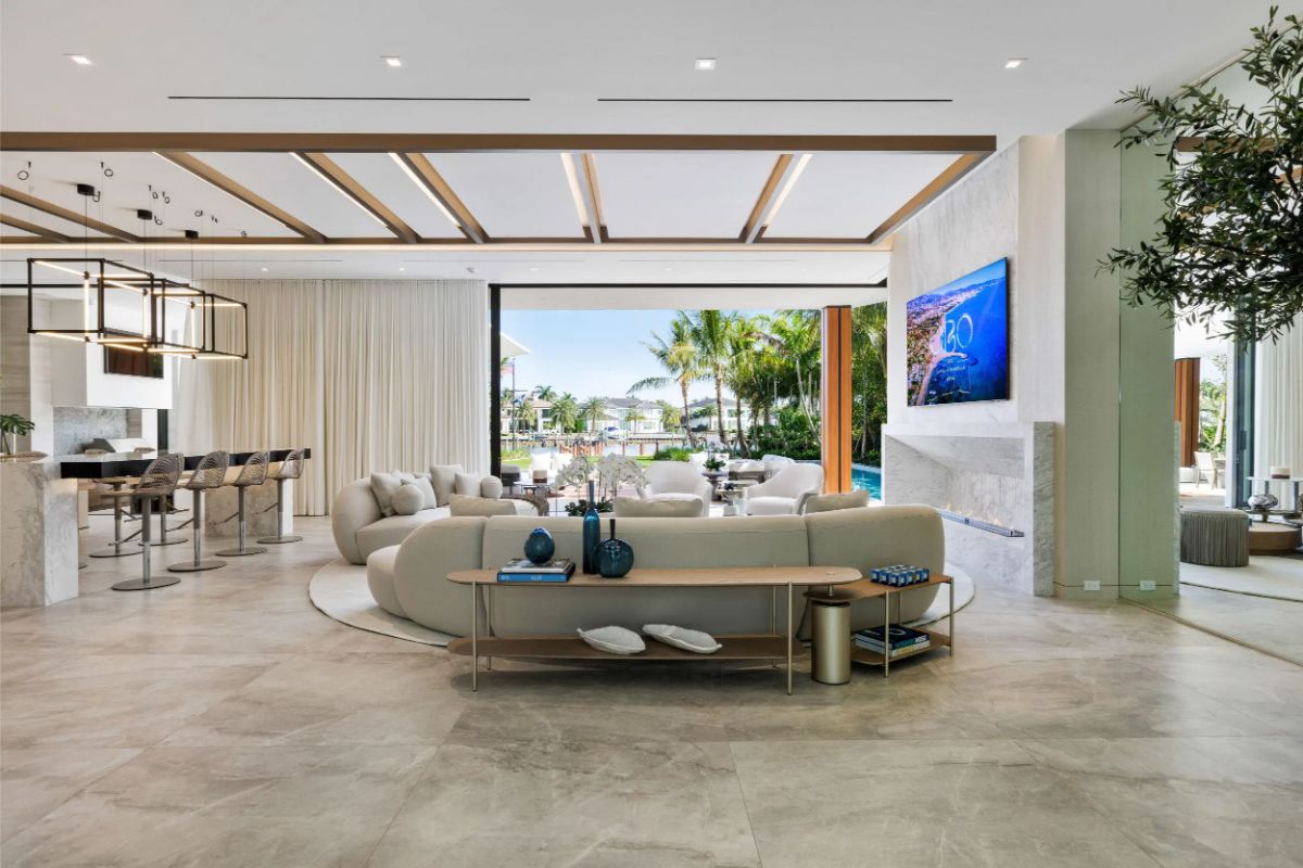 Open-concept living space flows effortlessly from the indoors to the poolside, featuring warm tones and modern textures. 