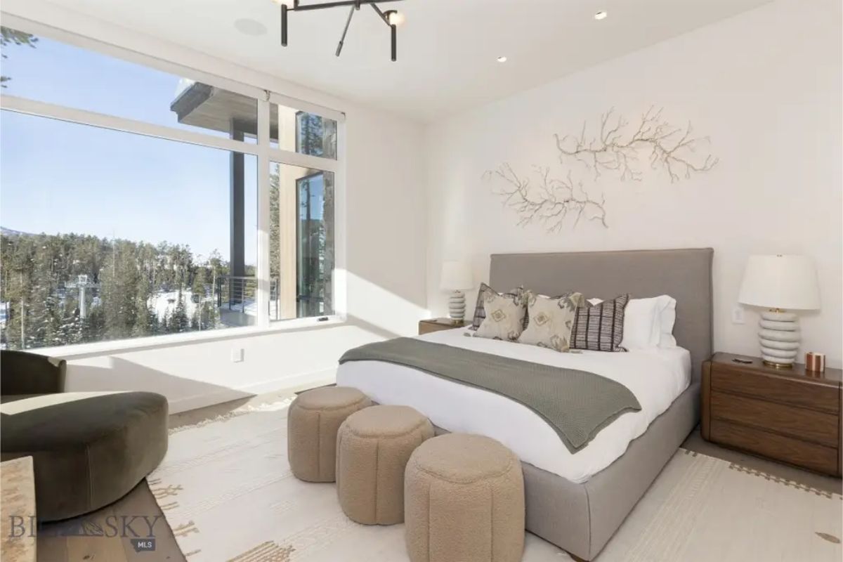 Elegant bedroom with soft textures, warm lighting, and decorative wall art for a serene retreat. 