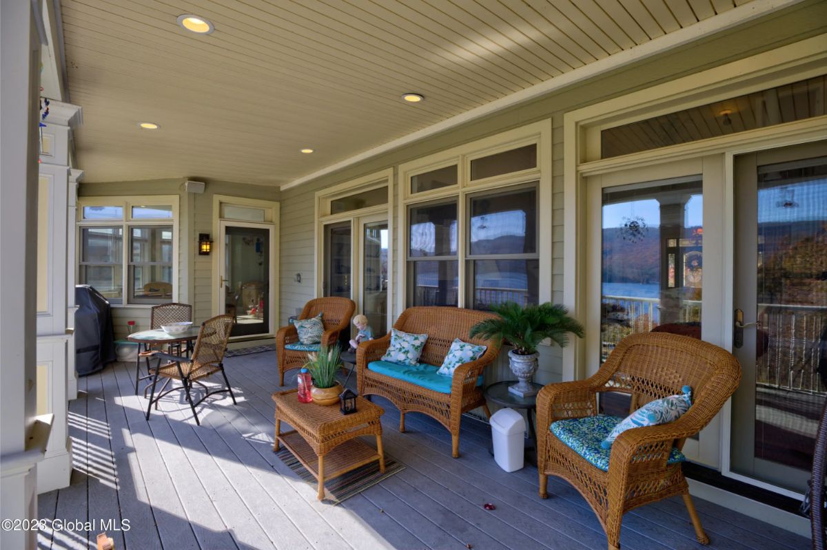 Wicker chairs and a loveseat are arranged around a small coffee table.