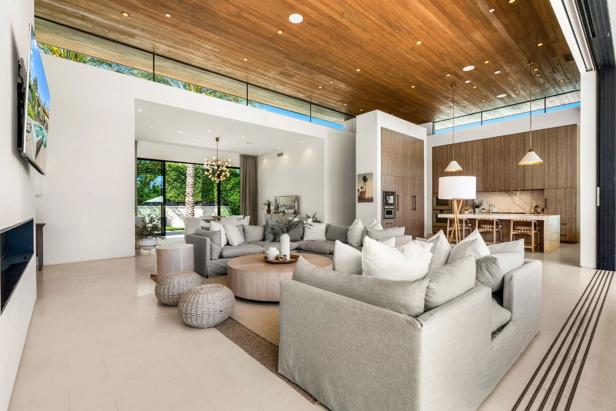Light tile flooring contrasts with wood plank ceiling and recessed lighting.