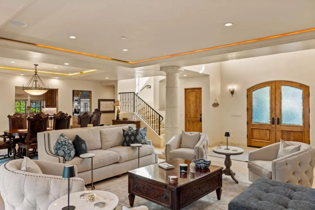 Double arched wood doors with frosted glass lead into a spacious open layout.