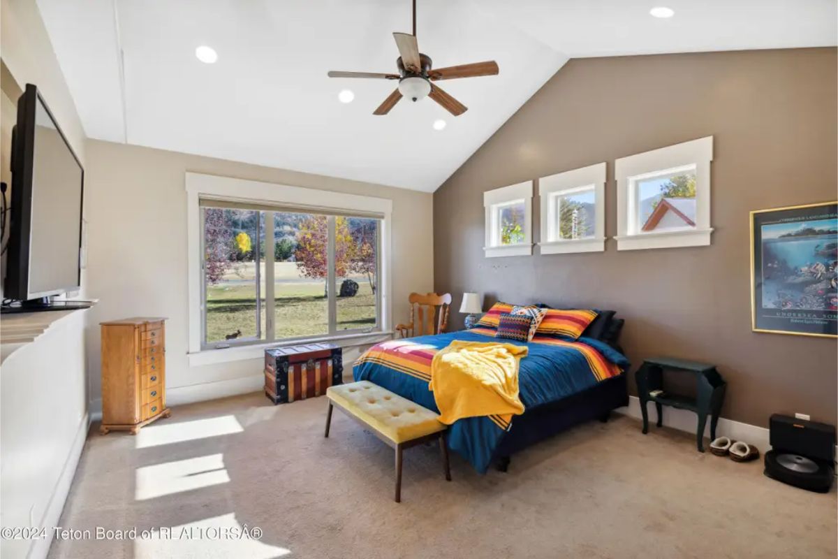 A vaulted ceiling with recessed lighting adds height to the space.