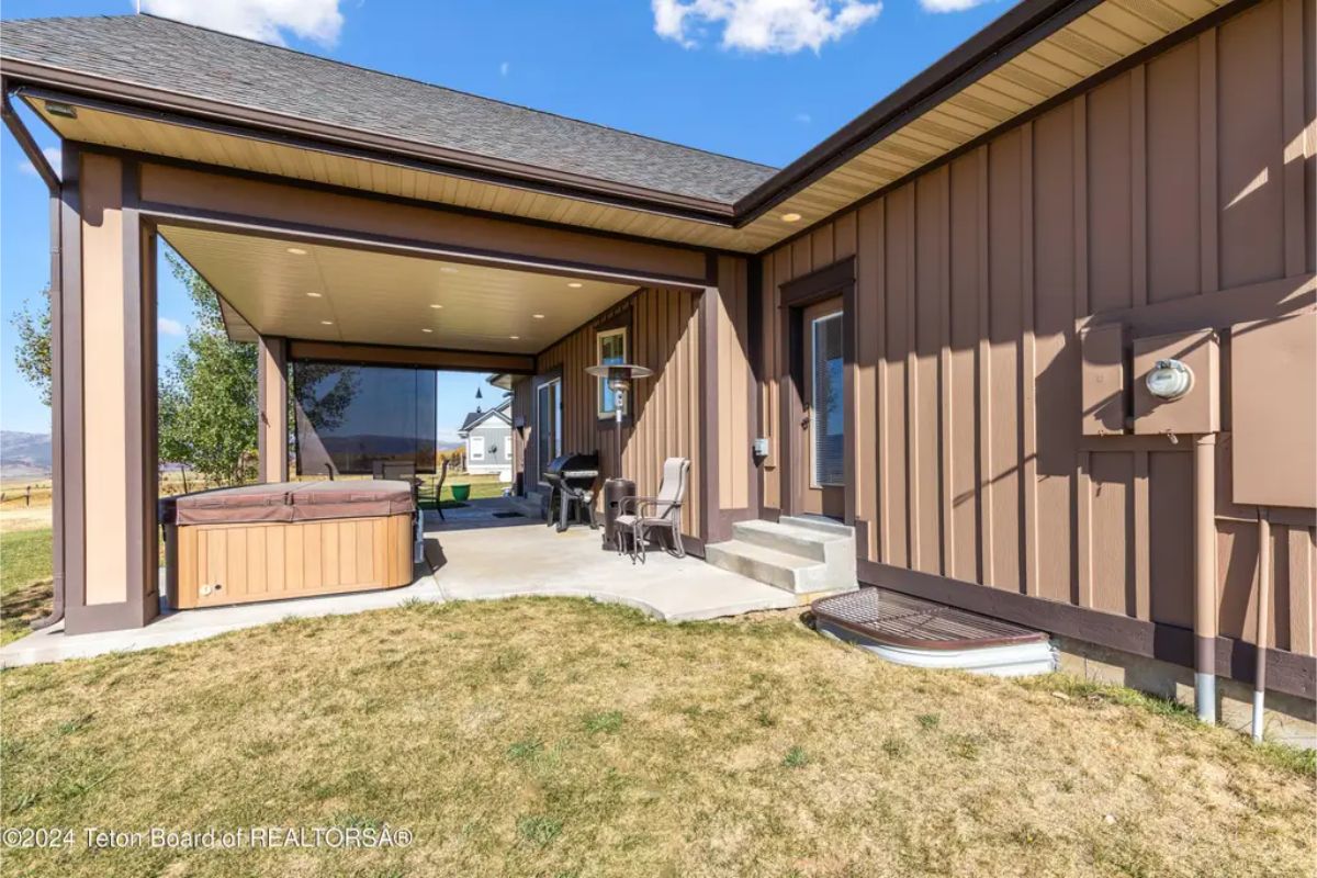 An extended covered patio area provides shaded outdoor space.