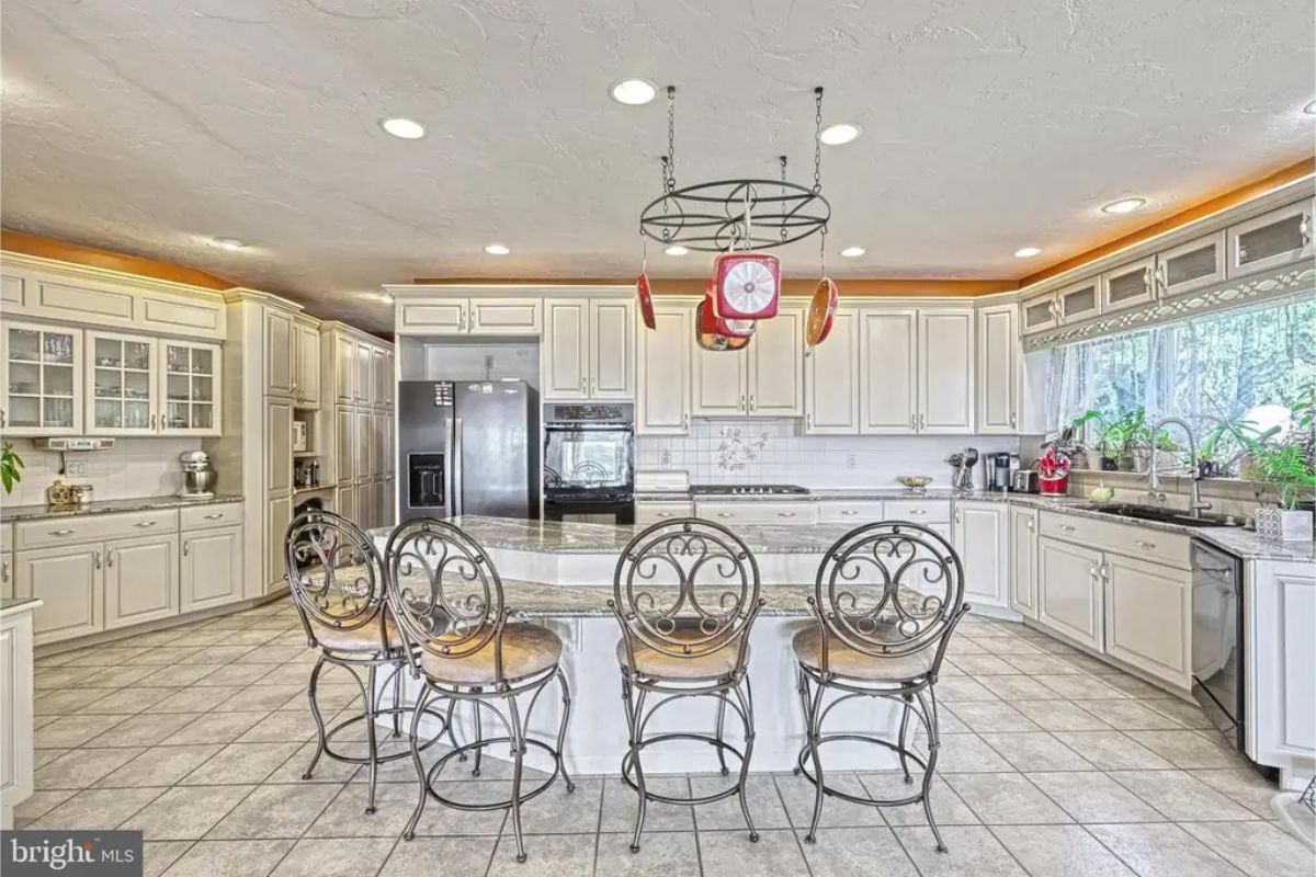 White cabinetry contrasts with black appliances.