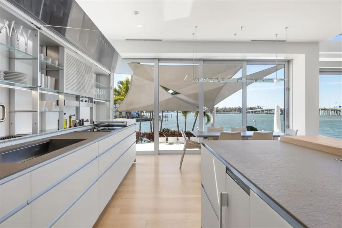 Ultra-modern kitchen with streamlined cabinetry, a spacious island, and a seamless indoor-outdoor flow. 