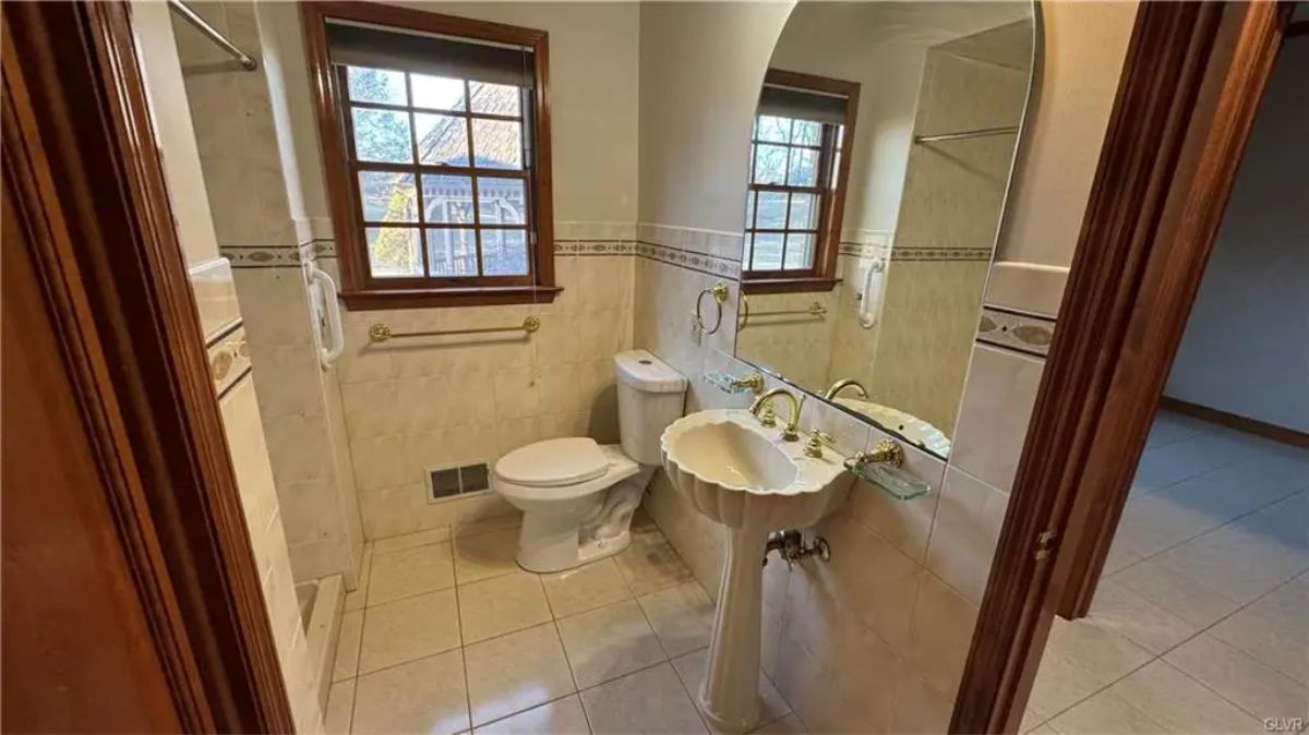 White tile walls with decorative border accents line the space.