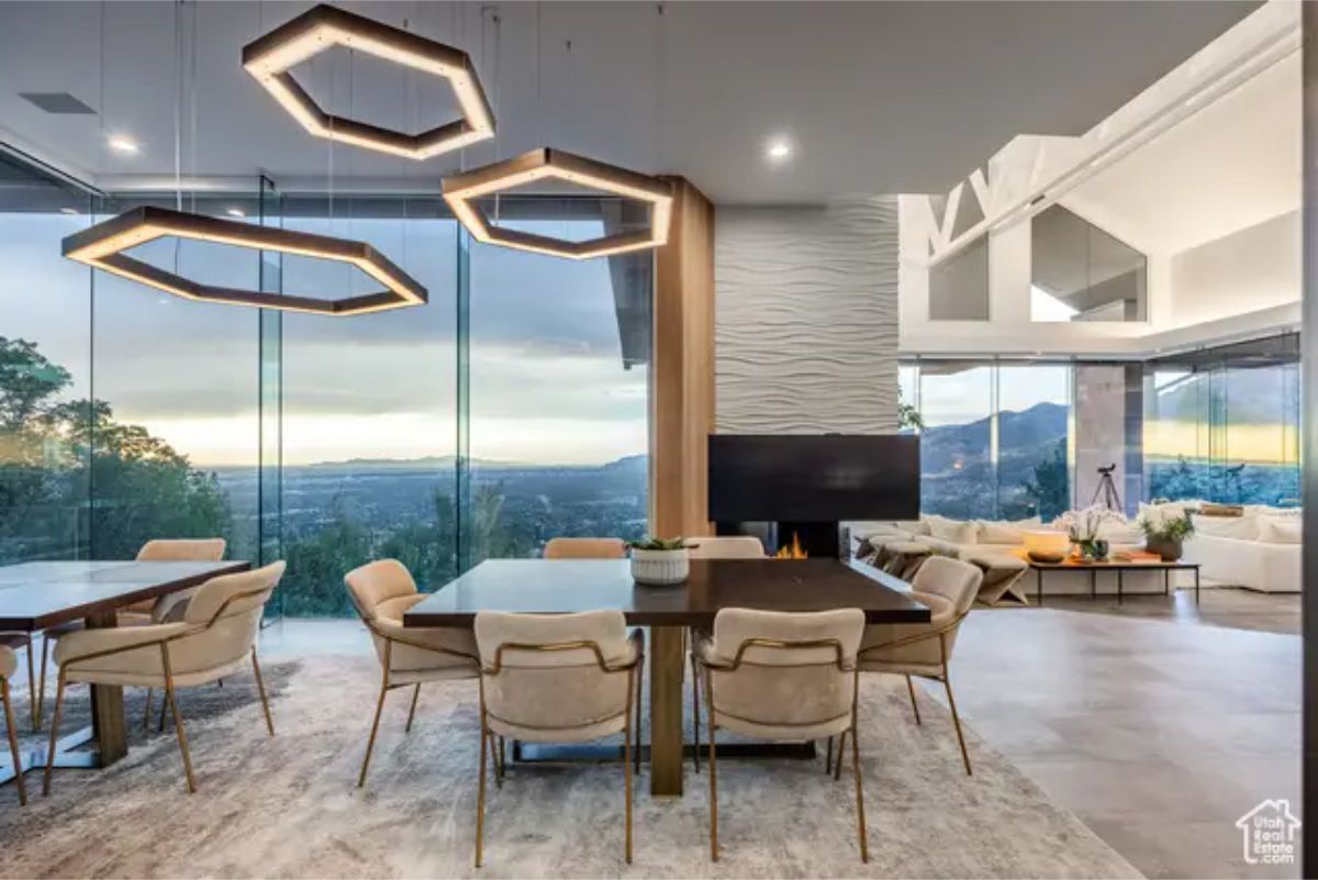 Elegant dining space with geometric pendant lights, luxurious seating, and an open-concept design. 