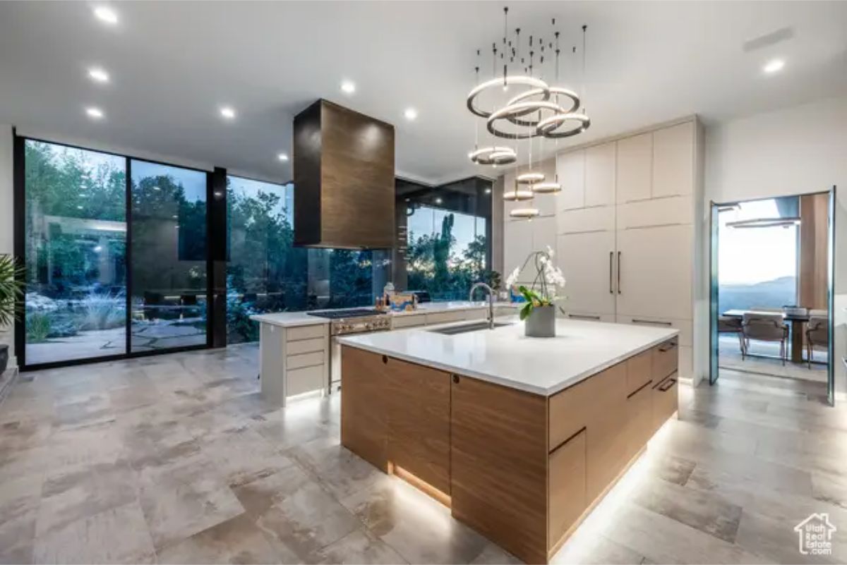 Modern kitchen with sleek cabinetry, a large island, and ambient lighting enhancing the contemporary aesthetic. 