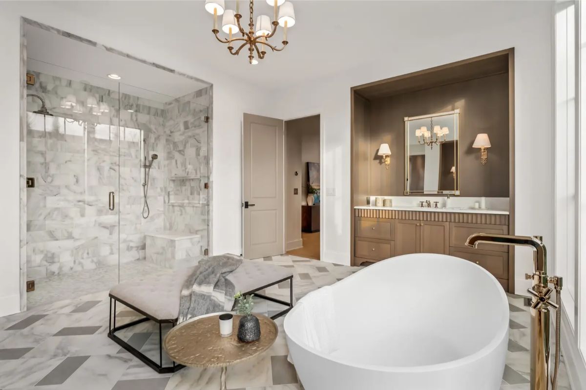 Alternate angle of the bathroom revealing a spacious glass shower and double vanity alcove. 