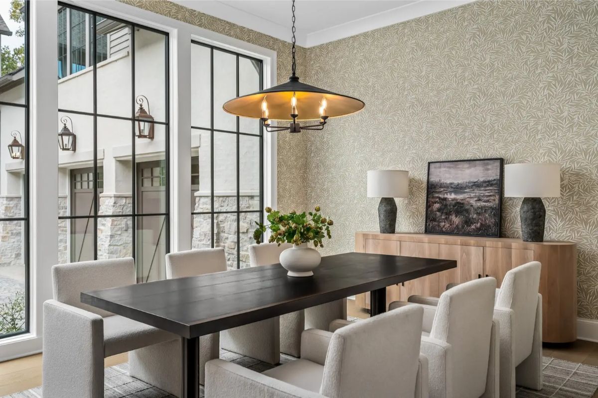Closer view of the dining area showcasing textured wallpaper, pendant lighting, and minimalist decor. 