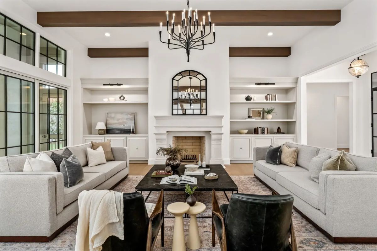 Centered view of the main living room with a cozy yet grand ambiance and symmetrical layout around the fireplace. 
