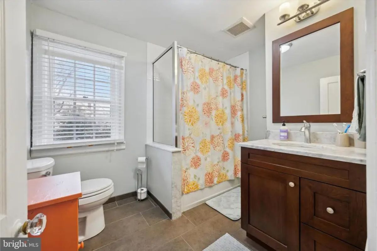 Bathroom with a dark wood vanity and a light-colored countertop.
