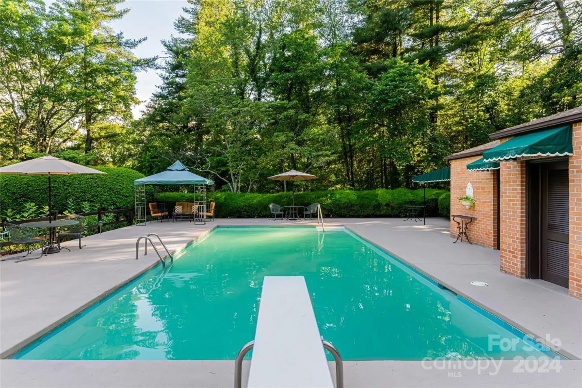 A rectangular in-ground pool is bordered by a wide concrete deck.