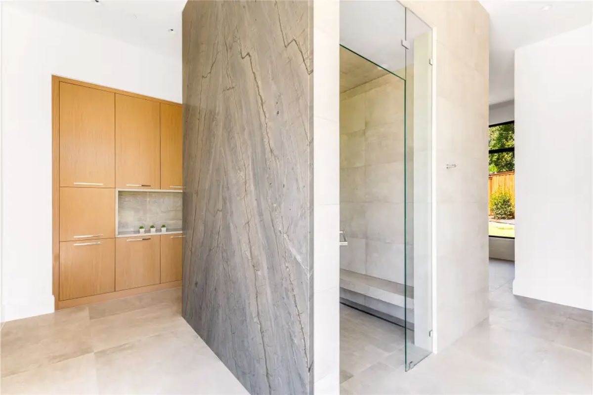 Another view of the same bathroom, showcasing its symmetry, modern fixtures, and outdoor scenery. 
