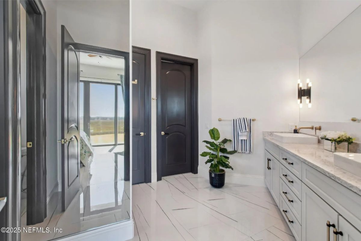 Modern bathroom with dual sinks and under-vanity storage in a light gray finish.