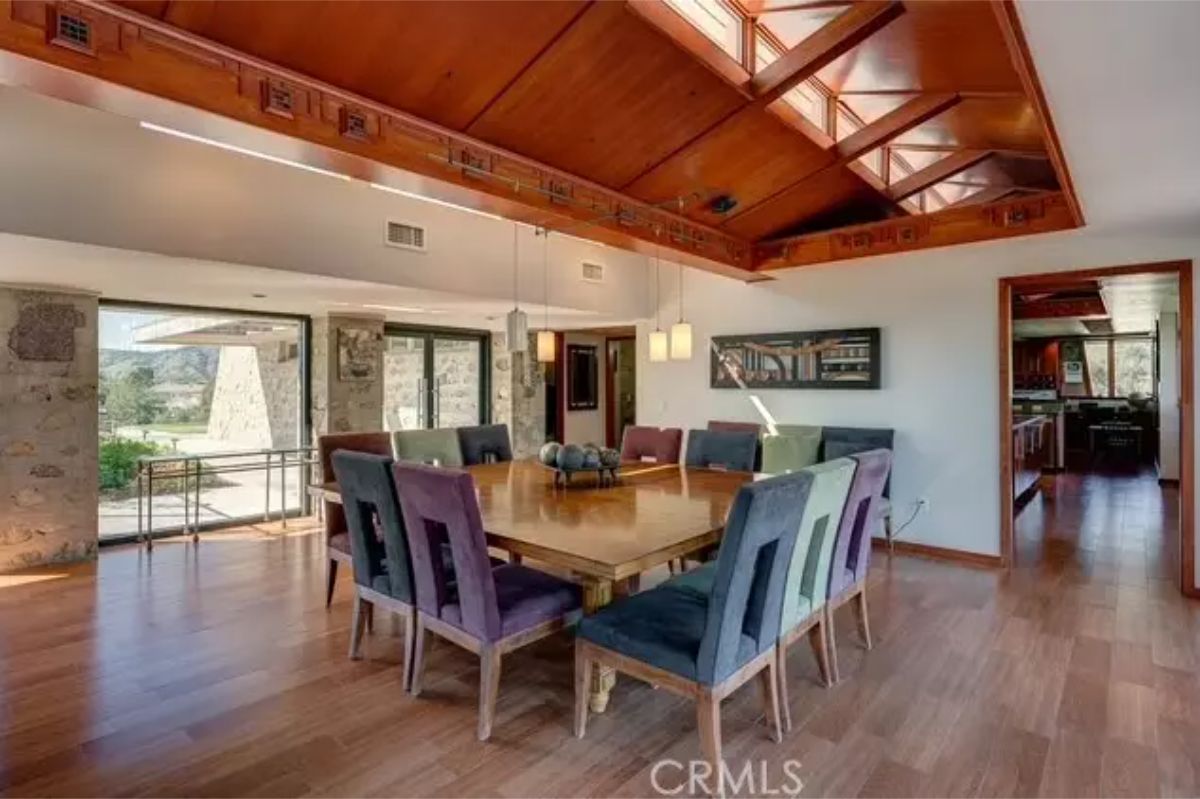 Dining room holds a long rectangular table with seating for ten.