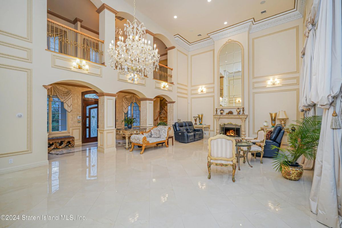 Double-height ceilings and a large crystal chandelier define the main gathering space.