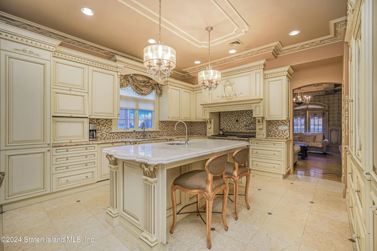Custom cream cabinetry with crown molding lines the walls.