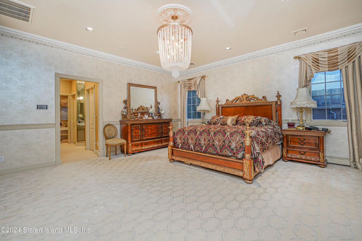Wood-framed bed and nightstands match the rich-toned dressers.