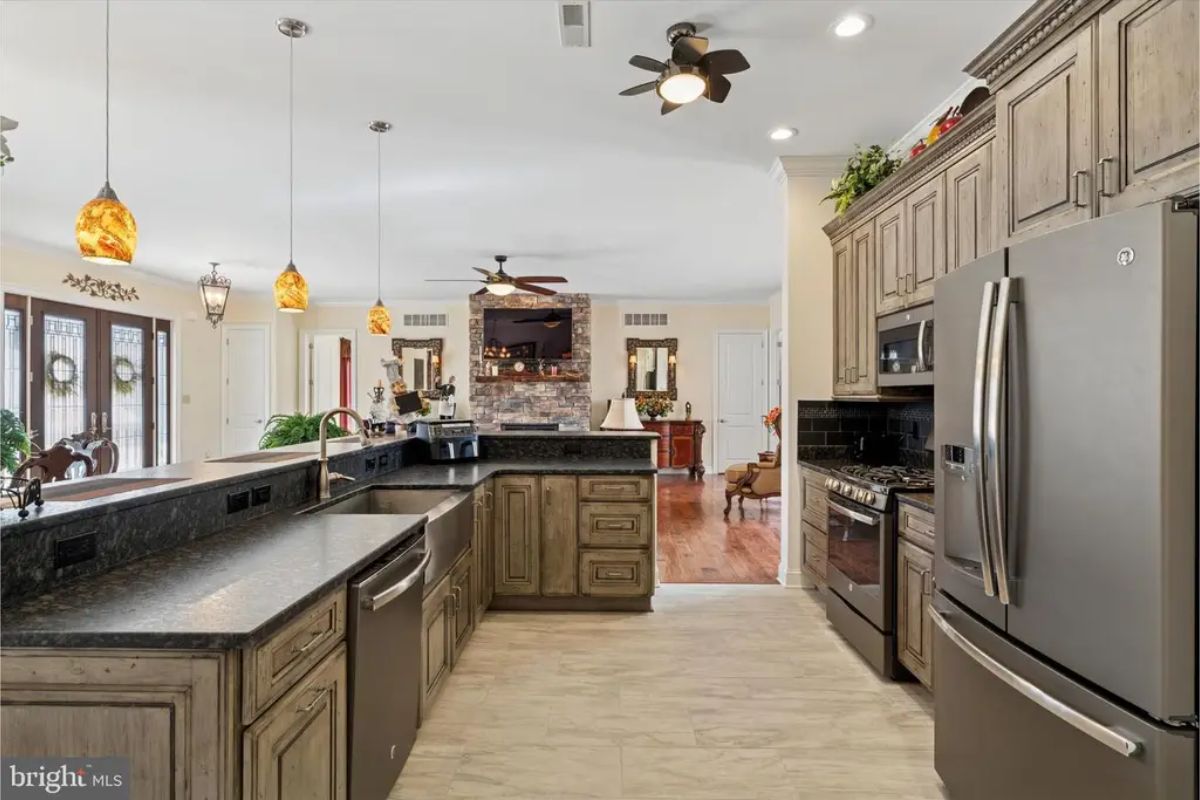 Dark wood cabinets contrast with light countertops and stainless steel appliances.