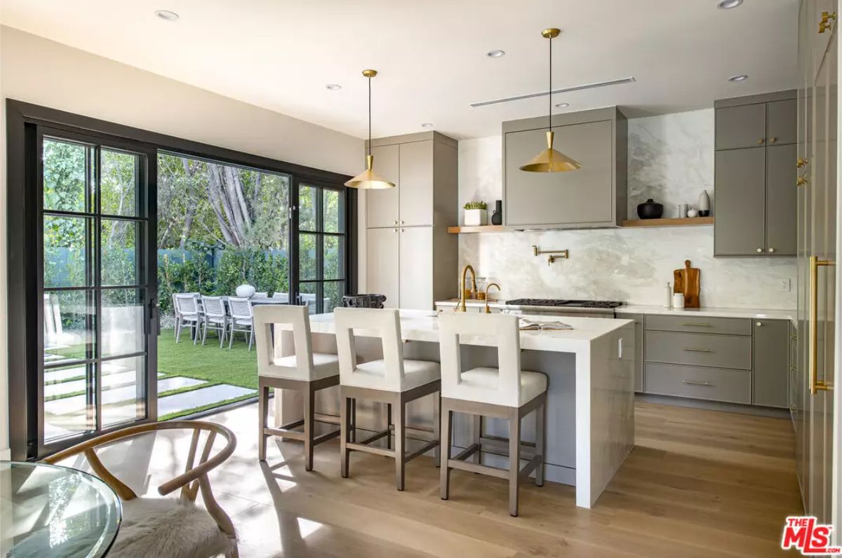 Large sliding glass doors open to a grassy backyard and dining area.