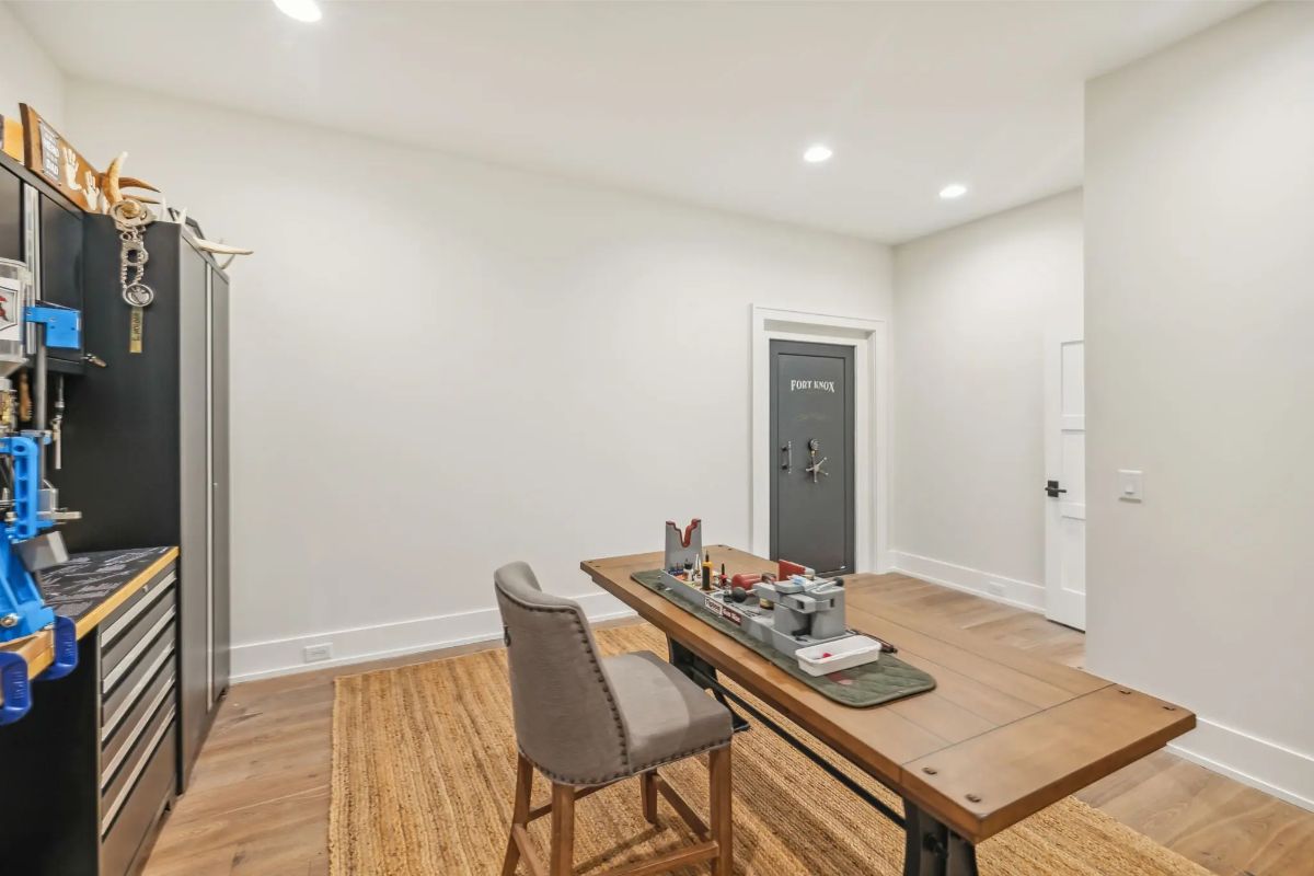 Multi-use workshop or hobby room with a large table, tool storage, and durable flooring. 