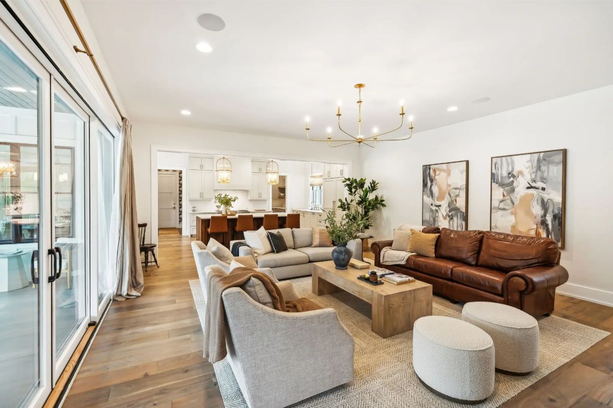 Cozy and stylish living room with a mix of textures, modern art, and elegant seating arrangements. 