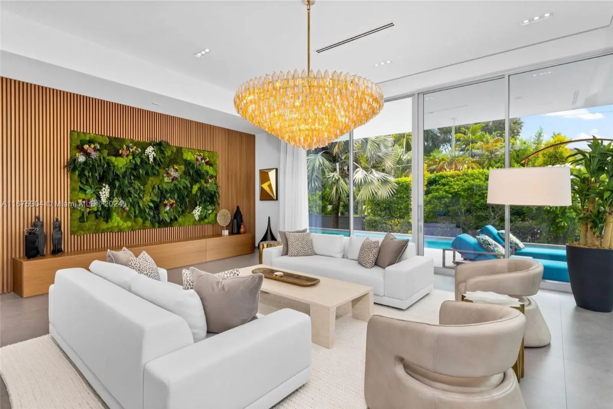 Living room showcases a green wall installation backed by vertical wood slats.