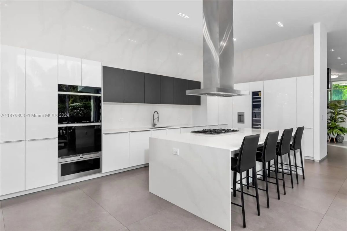 Kitchen uses black-and-white cabinetry in a clean, linear design.