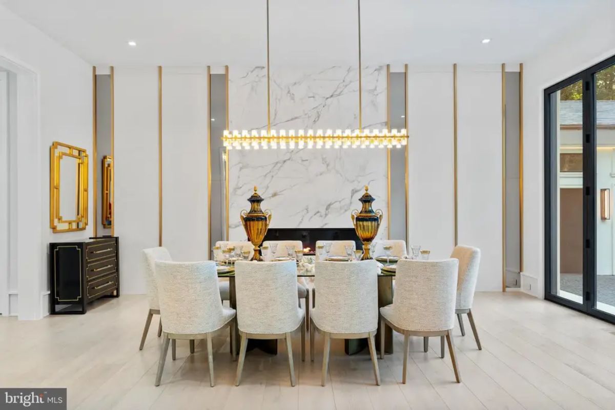 Rectangular dining table is surrounded by upholstered chairs in a neutral color palette.