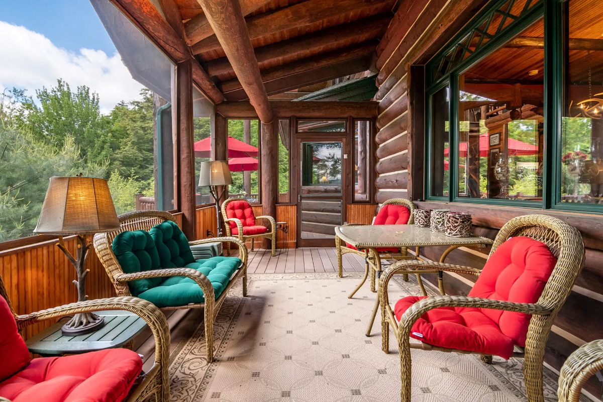 Wicker chairs and a dining table provide multiple seating options.