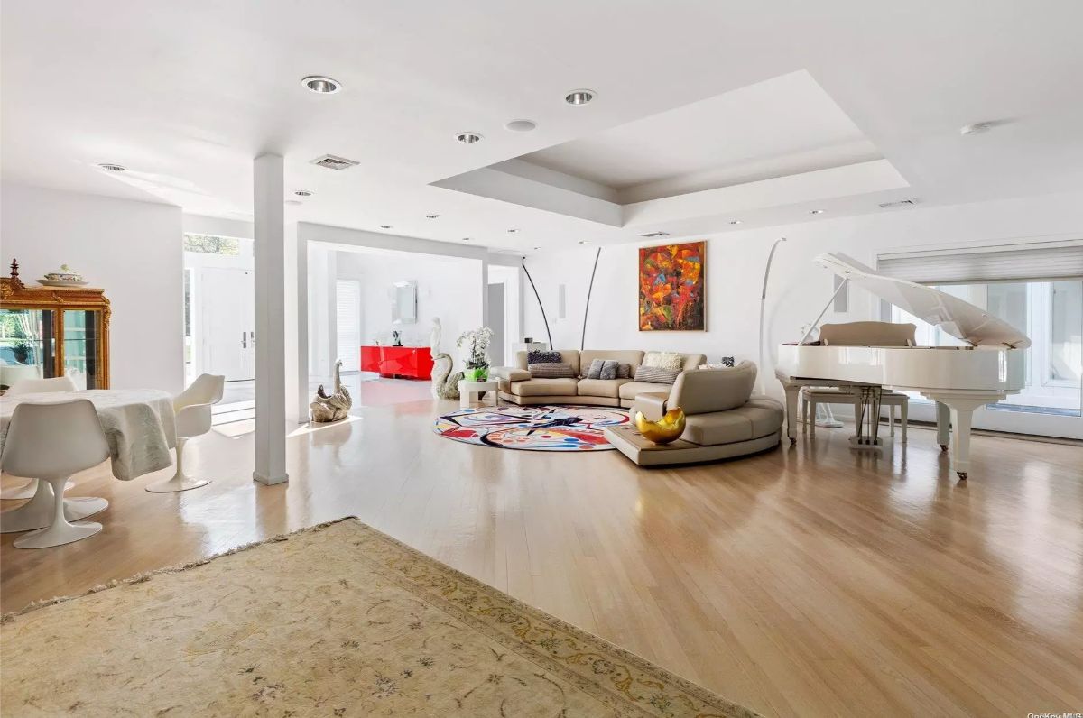 Curved sectional and colorful rug define the central seating area.