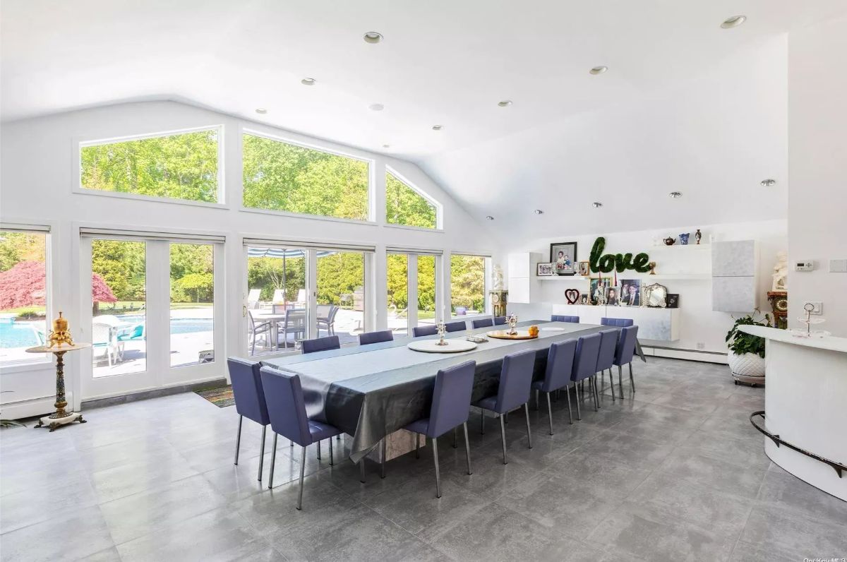 Oversized table with seating for at least 16 is placed along the center of the room.